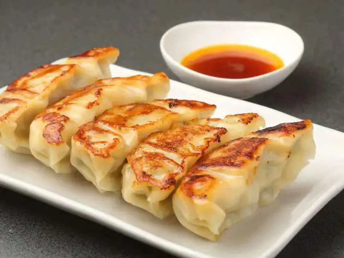Crispy pan-fried pork gyoza with dipping sauce at Joy Chalet Cuisine, an Asian Restaurant in Warrington